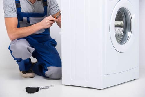 Electrician installing a washing machine